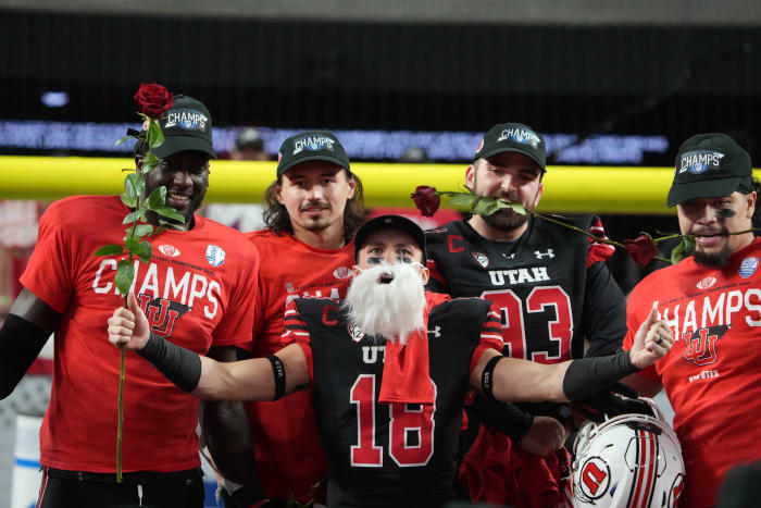 Utah Utes wide receiver Britain Covey (18), quarterback Cameron Rising (7) and Utah Utes long snapper Keegan Markgraf (93) celebrate after the 2021 Pac-12 Championship Game against the Oregon Ducks at Allegiant Stadium.Utah defeated Oregon 38-10.